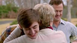 Grandmother welcomes and hugs teenage grandson and son-in-law Stock Footage