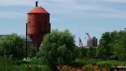 A flag flies half-mast in a Milwaukee Park Stock Footage