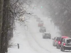 Winter snowstorm. Car traffic on slippery road. Stock Footage