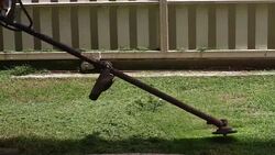 lawnmower man cutting grass in home gardening Stock Footage