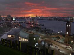 WS, HA, Dramatic sky at sunset above St. Pauli Landungsbrucken and harbor, Hamburg, Germany Stock Footage