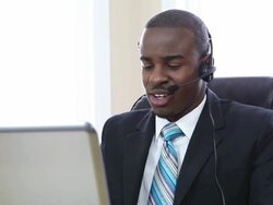 Customer support operator smiling and speaking in office Stock Footage