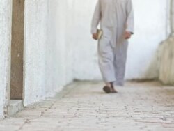 HD DOLLY: Muslim Pilgrim Walking Down Corridor Stock Footage