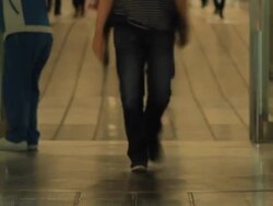 People walk through revolving door at airport Stock Footage