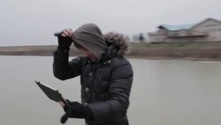 Young man taking selfie with tablet on frozen pond in winter in rural Montana, USA. Stock Footage