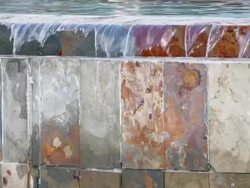Detail of infinity edge pool, water falling into slate wall Stock Footage