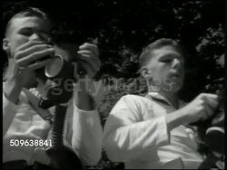 1941: US SAILORS IN TRAINING: US Sailors standing in formation. Group of US Sailors putting on gas masks (dark). MS Two US Sailors putting on gas masks. US Sailors receiving instruction on how to hold rifle, strap, other sailors watching. Instructional Video