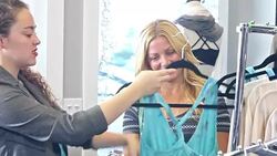 Salesperson helping customer in clothing store Stock Footage