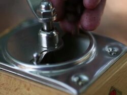 man grinds fresh roasted coffee beans with an antique style Stock Footage