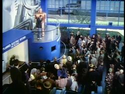 1940 high angle man standing next to large robot talking to crowd below / New York World's Fair / industrial Stock Footage
