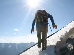 Mountaineer jumps overhead camera Stock Footage