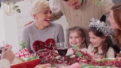 Family and friends enjoying Christmas dinner at table Stock Footage