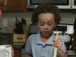 'Slow motion pan of mother, boy, and girl mixing ingredients.' Stock Footage
