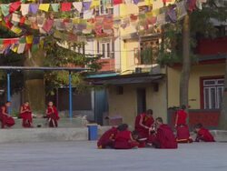 WS Young Buddhist monks eating lunch in courtyard / Kathmandu, Central Region,Nepal Stock Footage