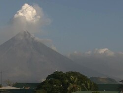 Wide shot of Mayon volcano spewing ash and steam over Legazpi city, Philippines, Dec 2009 Stock Footage