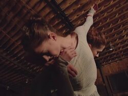 low angle shot of two dancers dancing in wooden barn Stock Footage