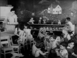 B/W 1934 PAN children at tables being served snack in nursery school / WPA project / newsreel Stock Footage