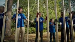 Volunteers high five holding frame Stock Footage