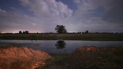 Astrophotography star trails on summer night sky with cloud over Lake Stock Footage