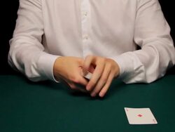 MS man shuffling and cutting deck then producing four aces Stock Footage