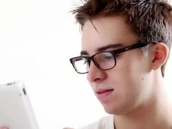 Young man with glasses using digital tablet. Stock Footage