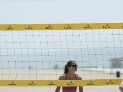CU of female beach volleyball players spiking and blocking at the net and digging. Stock Footage
