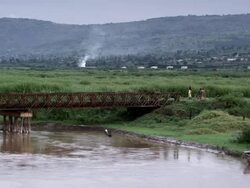 Exterior steady shot of river with bridge in view. Travel destination Stock Footage