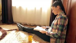 Young woman reading on the floor reading. Stock Footage