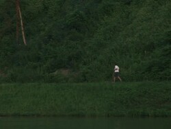 Man running in nature by river Stock Footage
