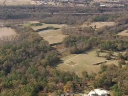 MS AERIAL DS ZI Shot of Ocmulgee Nat Monument & Indian Mounds surrounded by trees / Georgia, United States Stock Footage