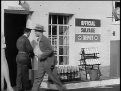 Black and white 1943 men dropping off scrap metal at salvage depot / World War II / newsreel /AUDIO Stock Footage
