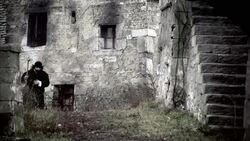 Nostradamus walks on a path through a town. Stock Footage