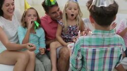 Boy bringing birthday cake to sister in living room Stock Footage