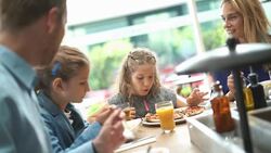 Family having lunch at a restaurant. Stock Footage