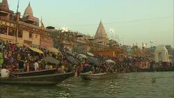 Bathers gather at a river in India. Stock Footage