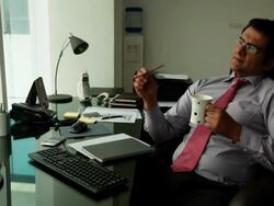 Businessman drinking tea in an office  Stock Footage
