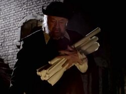 A man burns pages of Nostradamus' writings in a fire. Stock Footage