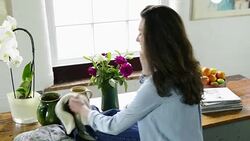 Woman picking up jacket and keys Stock Footage