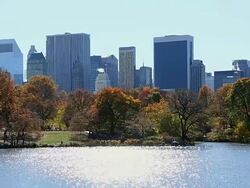 WS PAN Shot of autumn color trees and Manhattan skyline and Lake which illuminated by sun / New York, United states Stock Footage
