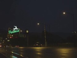 MS Shot of Cars drive in rain in front of Portland Oregon sign at night / Portland, Oregon, United States  Stock Footage