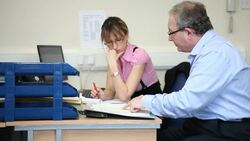 Office manager instructing female worker. Stock Footage