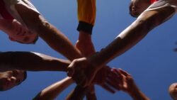 A team of soccer players join hands to prepare themselves for a game. Stock Footage