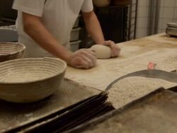 MS PAN Baker kneads dough and put it in baskets / Copenhagen, Seeland, Denmark    Stock Footage
