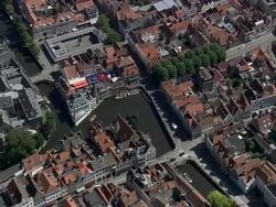 MS AERIAL ZI ZO PAN Tourist roaming through boat in Bruges canal in city / Flanders, Belgium Stock Footage