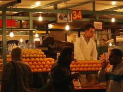 MS Shot of man behind fruit stand serving juice to customers at night / Fes, Centro-North, Morocco/ Fes, Centro-North, Morocco Stock Footage