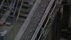 Chunks of rock move up a conveyor belt in the mining process. Stock Footage