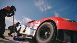 Stock car pit-crew jackman lowers race-car, gives driver thumbs-up Stock Footage