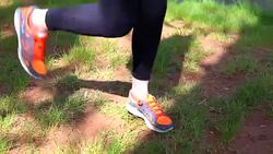 Young woman using a jump rope in park near river Stock Footage