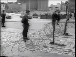 B/W 1961 soldiers standing guard at barbed wire fence of Berlin Wall / Germany / newsreel Stock Footage