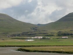 WS View of small power plant at bottom of large mountains with sheep grazing in fields / Reykjavik, Hofudhborgarsvaedhi, Iceland  Stock Footage